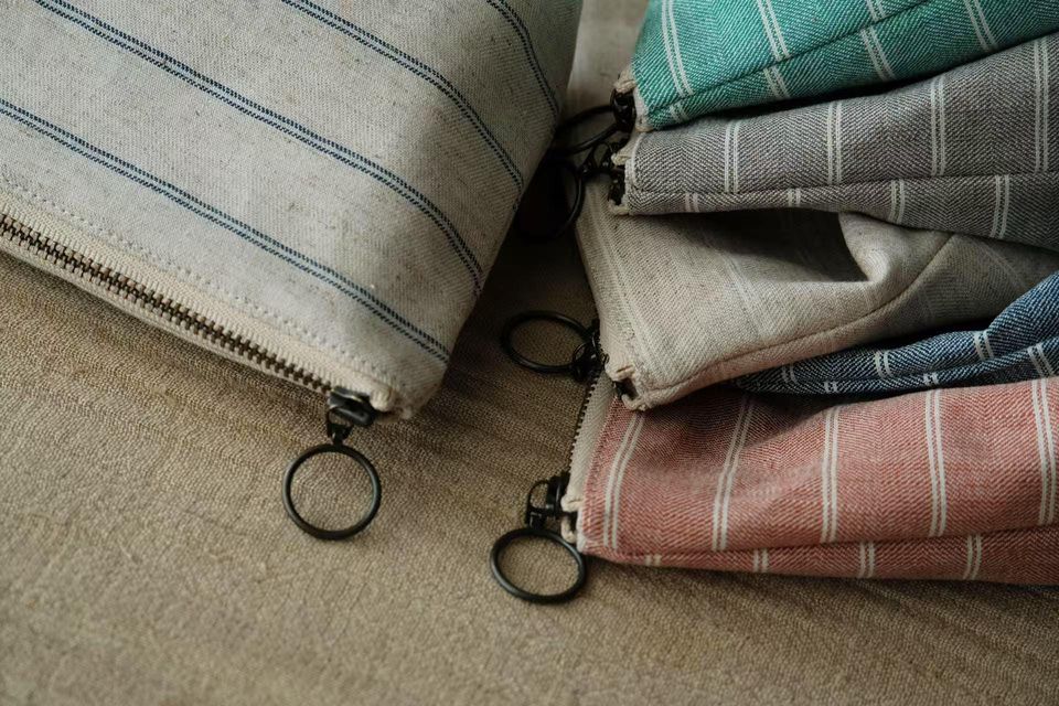 Minimalist striped cotton-linen makeup bag. Sustainable pouch in natural woven fabric