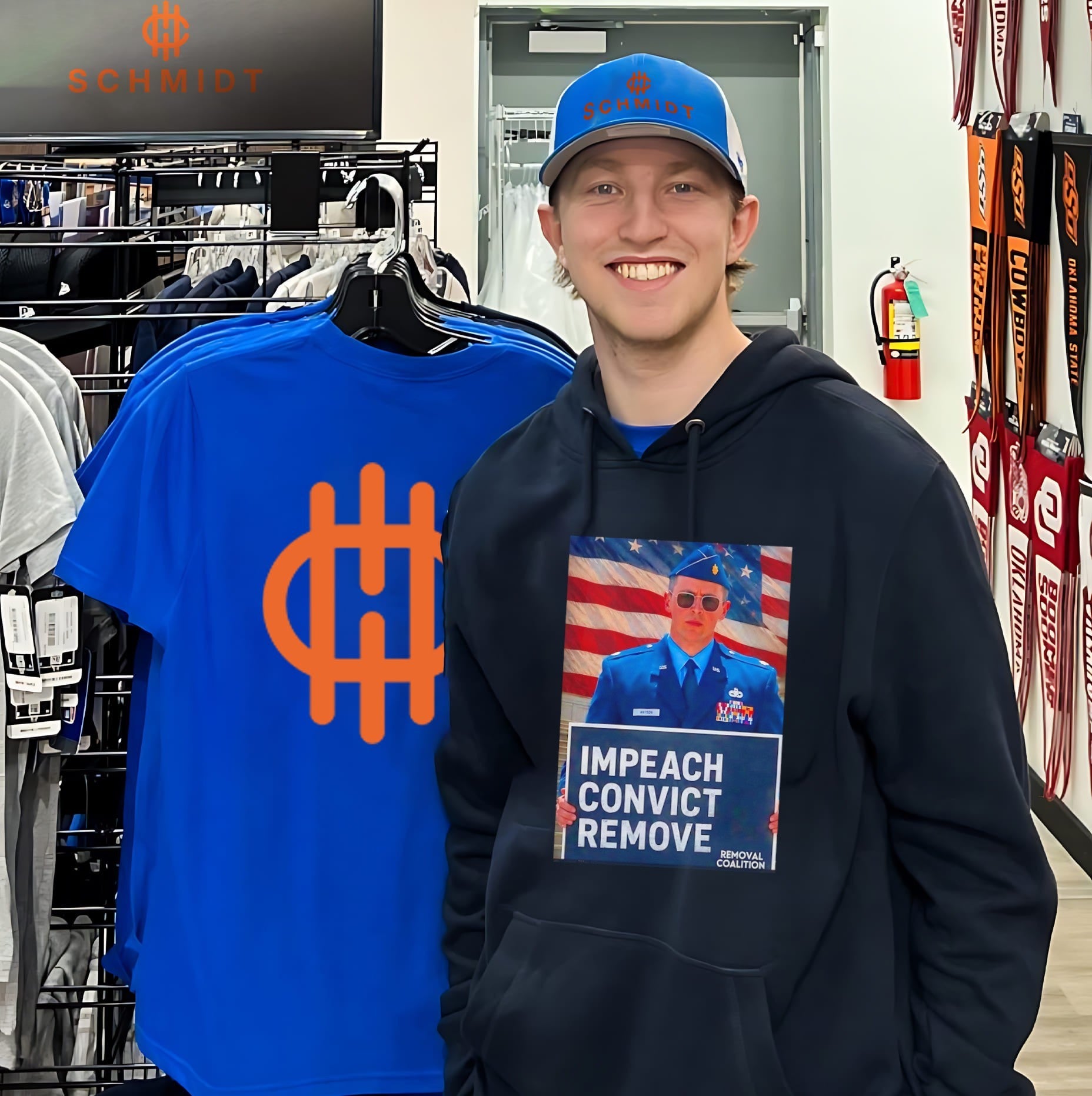 Major Jason Watson holding sign impeach convict remove shirt